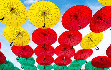 Fototapeta na wymiar Decorative umbrellas hanging sky background