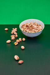 Fototapeta na wymiar Tasty nuts on a green table.