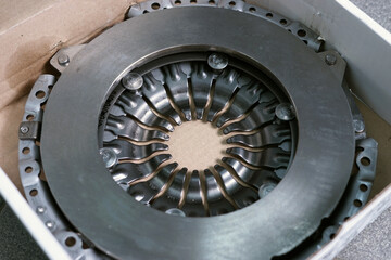 New original high quality clutch basket. Detail for the repair of a modern car. Selected focus.