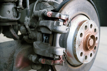 Brake caliper installed on a modern car during maintenance and repair. Selected focus.