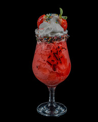 A glass of delicious strawberry milkshake (smoothie ) on wooden background served with fresh strawberry on it.