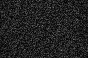 Close-up of black plastic polymer granules background