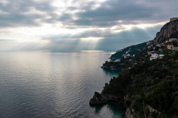 Panoramic sunset view on Amalfi Coast from the Path of the Gods (Sentiero Degli Dei) in Campania, Italy, Europe. Hiking trail from Praiano to Amalfi. Coastal town in the Province of Salerno. Overcast