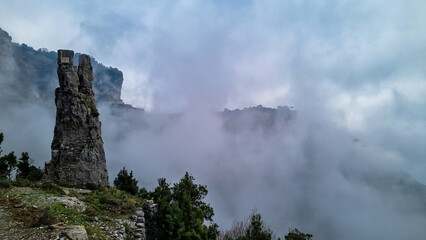 A pinnacle like rock formation on the famous Path of the Gods (Sentiero Degli Dei) on the Amalfi Coast in Campania, Italy, Europe. Hiking trail to San Lazzaro is covered with mystical fog.