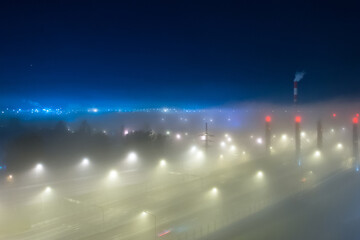 Thick fog over night highway in the city.