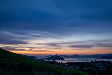 Naklejka na ściany i meble Morning Silhouette of San Francisco Skyline from Marin County, Blue Pink Orange Sky with city in distance across the San Francisco Bay