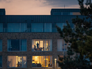Man Looking Out the Window of an Apartment at Sunset, Ireland