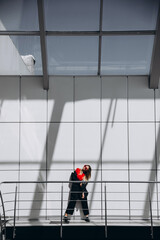 The interesting female is standing near the wall and having fun while posing.