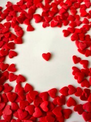 Red heart surrounded by red hearts on a white background. 