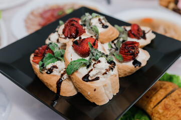 Canape with cream cheese and strawberries. wedding reception