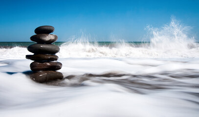 Wonderful nature Shining and polished stones piled on the shore with many polished stones on the Crimean peninsula. The background is the sea, a pebble beach with some other islands.
