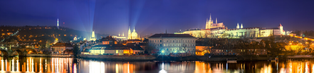 Fototapeta na wymiar Night Time Panoramic of Illuminated Lesser Town, from Prague Castle to Charles Bridge with Lights Reflecting off the Vltava River, European Tourist Destination