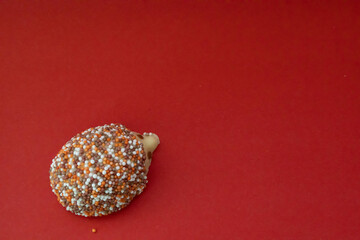 One hedgehog chocolate with a red background with copy space