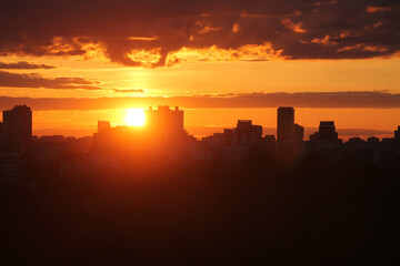 Cityscape with silhouette of city skyline against setting sun. Minsk, Belarus