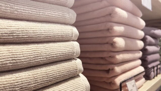 Stacks of terry towels lie on the shelves of a home improvement store. Closeup