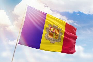 Sunny blue sky and a flagpole with the flag of andorra