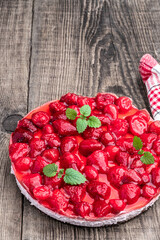 Delicious strawberry tart on wooden background
