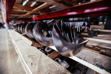 Augers. Screw machine parts in the factory, close up, selective focus