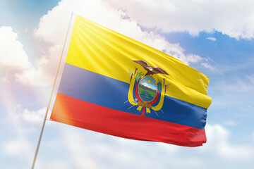 Sunny blue sky and a flagpole with the flag of ecuador