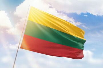 Sunny blue sky and a flagpole with the flag of lithuania
