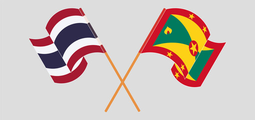 Crossed and waving flags of Thailand and Grenada