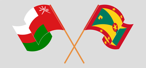 Crossed and waving flags of Oman and Grenada