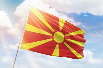 Sunny blue sky and a flagpole with the flag of north macedonia