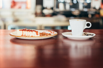 cheesecake and coffee at the bar of a restaurant