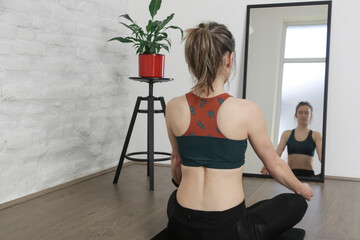 Young woman practicing meditation and breathing exercises. Wellbeing and self care concept.	