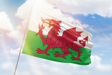 Sunny blue sky and a flagpole with the flag of wales