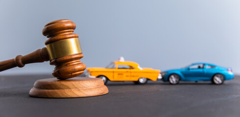 Judge gavel and two cars colliding