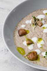 A bowl of Mushroom Cream Soup with fried champignons. Winter, autumn hot soup concept