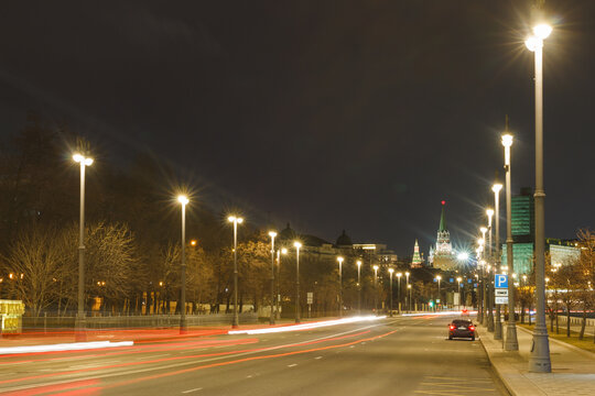 Moscow, Russia, Apr 13, 2022: Night view of Prechistenskaya embankment. The Moscow Kremlin in background