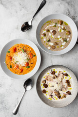 Soup Assortment. Set of various seasonal vegetable soups and organic ingredients, banner, copy space. Homemade colorful soups.