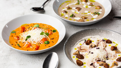 Soup Assortment. Set of various seasonal vegetable soups and organic ingredients, banner, copy space. Homemade colorful soups.