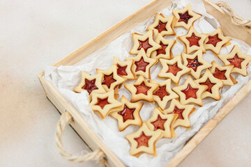 Fototapeta na wymiar Star shaped linzer cookie strawberry jam