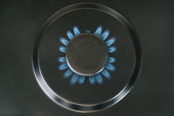 Gas is switching on, appearing blue flame. Kitchen burner turns on