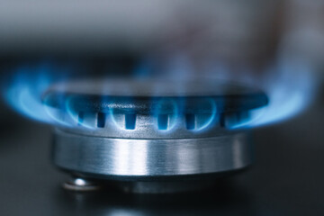 Kitchen burner turns on. Gas is switching on, appearing blue flame