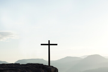 Cross silhouette on mountain nature background