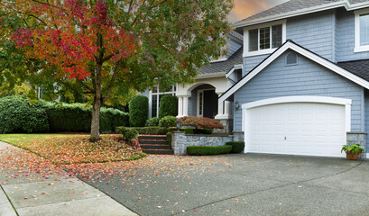 Early autumn residential single family home with colorful tree and sky - 501438032