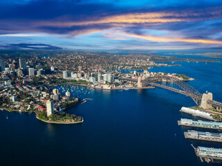 Fototapeta premium Sydney Harbour Australia with nice colours in the sky. Nice blue water of the Harbour, high rise offices and residential buildings of the City in the background, NSW Australia