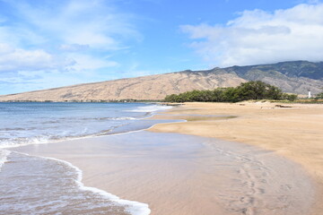 Maui Hawaii beach with wind turbines on hill