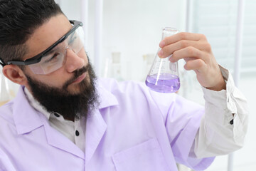 Close up Scientist looking at lab bottles Shake the bottle containing the chemical. Scientists working in a laboratory