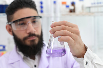 Close up Scientist looking at lab bottles Shake the bottle containing the chemical. Scientists working in a laboratory