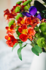 beautiful large bouquet of different fresh flowers: irises, orchid, greenery. holiday card. cover for printing. selective focus