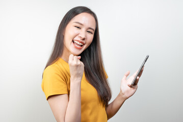 Naklejka premium Happy asian woman smile when lucky win game on mobile phone.