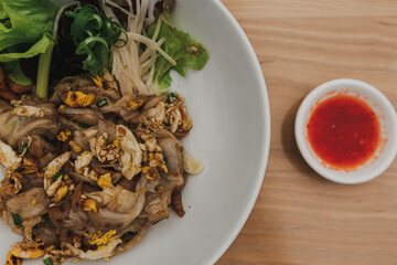 Pad See Ew is a stir-fried noodle dish that is commonly eaten in Thailand.