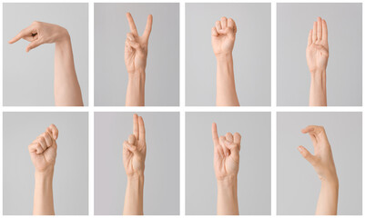 Hands showing different letters on grey background. Sign language alphabet