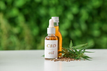 Bottles of CBD oil on table outdoors