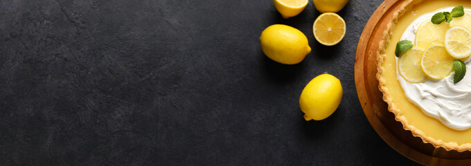 Delicious lemon tart on dark background with space for text